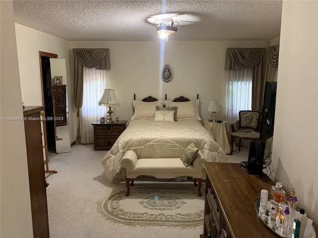 carpeted bedroom with a textured ceiling