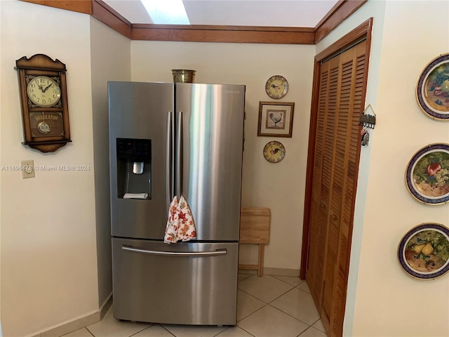 kitchen with stainless steel fridge and light tile patterned floors