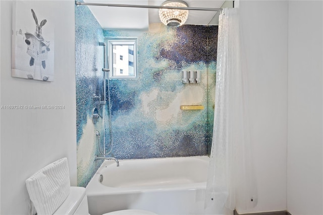 bathroom with shower / tub combo and toilet