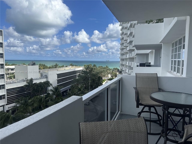 balcony with a water view and a beach view