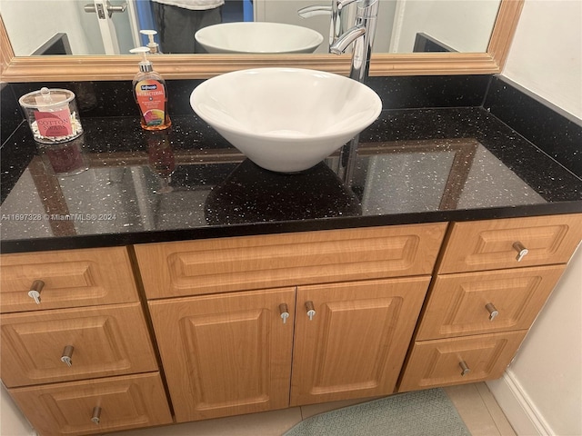 bathroom featuring tile patterned flooring and vanity