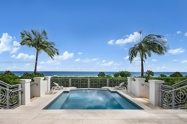 view of swimming pool with a water view