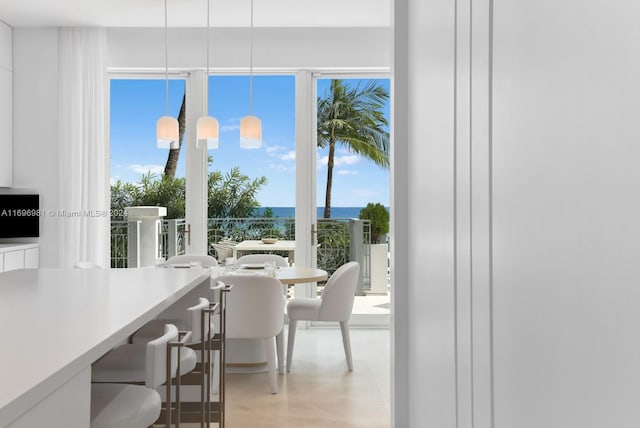 dining space featuring light hardwood / wood-style floors and an inviting chandelier