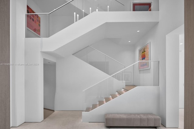 stairs featuring a towering ceiling