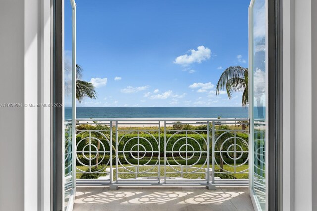 balcony featuring a water view and a beach view