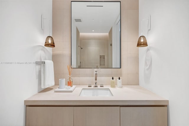 bathroom with tasteful backsplash, vanity, and walk in shower