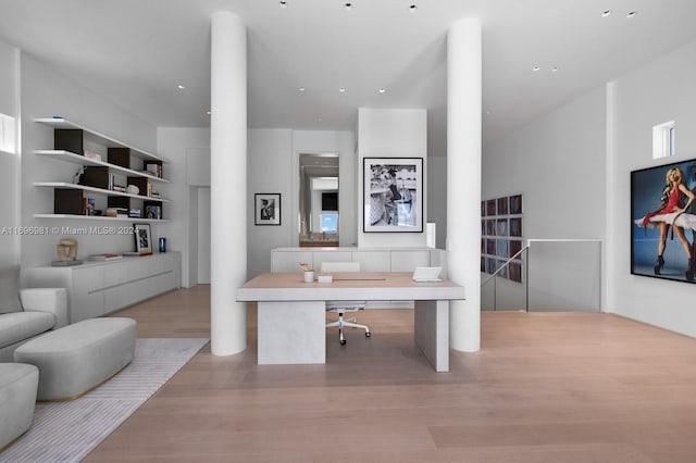 office area with light hardwood / wood-style floors