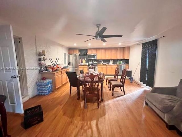 dining area with ceiling fan and light hardwood / wood-style flooring