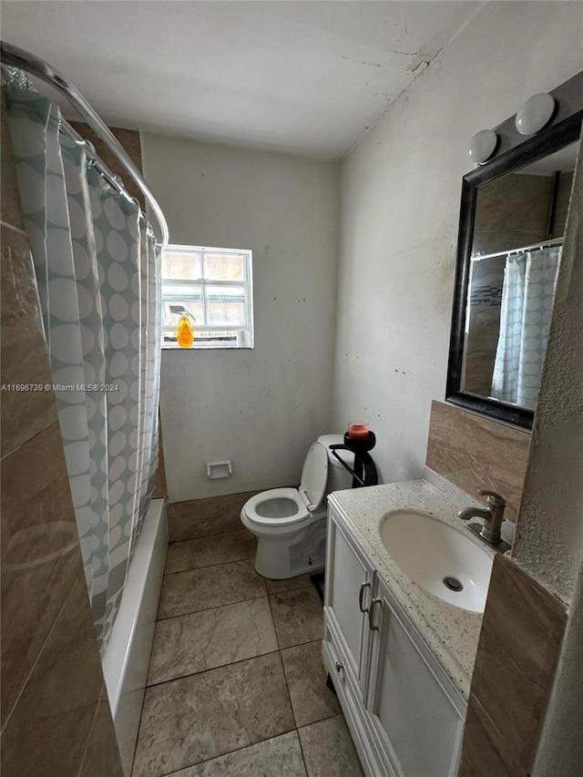 bathroom featuring tile patterned floors, vanity, and toilet