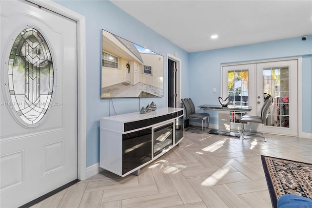 foyer entrance featuring light parquet flooring and french doors