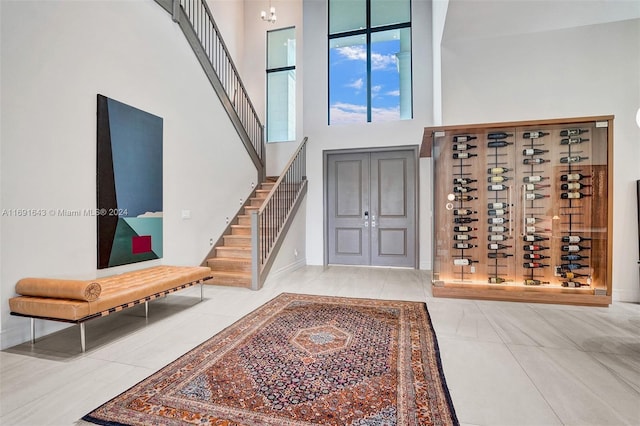 entrance foyer with tile patterned flooring and a high ceiling