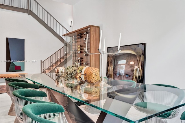 dining space with a towering ceiling