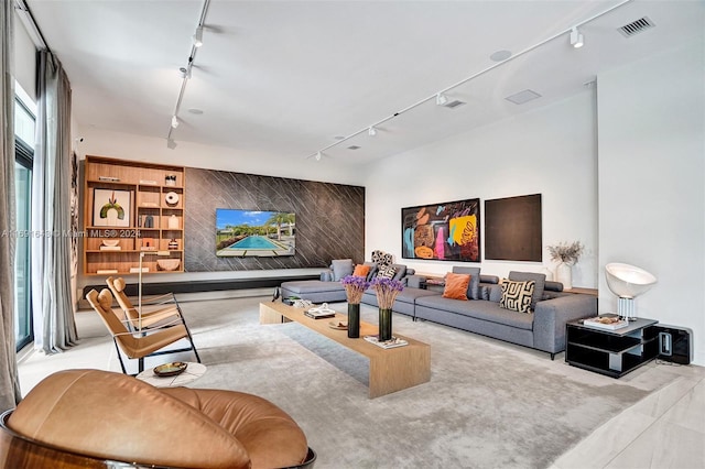 living room with a healthy amount of sunlight and rail lighting