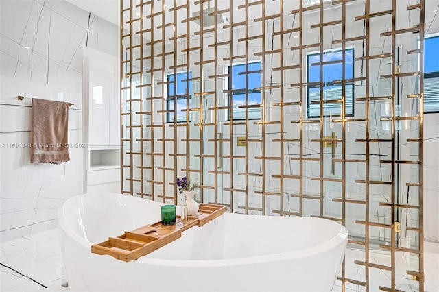 bathroom with tile walls and a tub