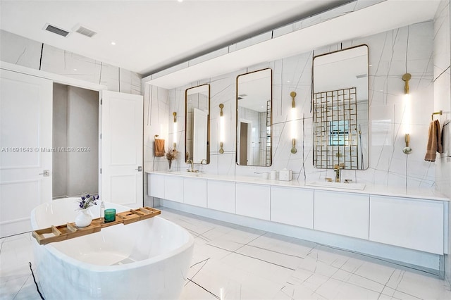 bathroom with vanity, tile walls, and a bathing tub