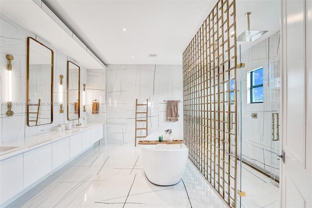 bathroom featuring vanity, tile walls, and independent shower and bath