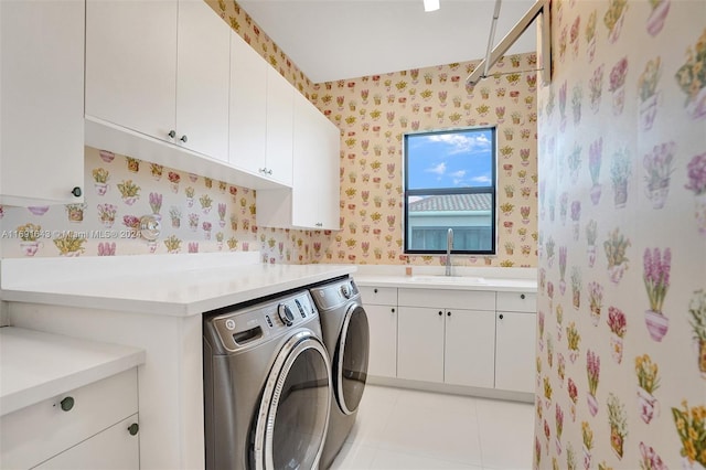 washroom featuring washer and clothes dryer, cabinets, light tile patterned floors, and sink