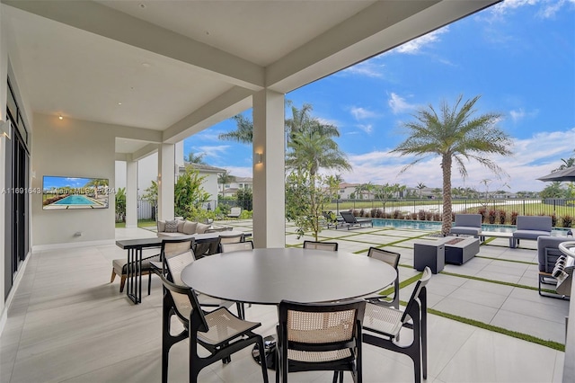 view of patio featuring a fenced in pool and a fire pit