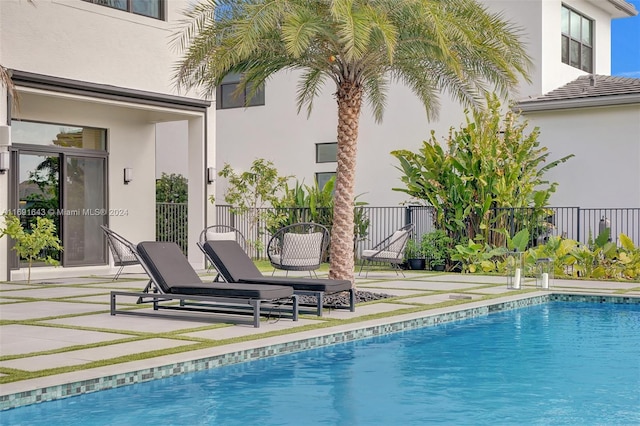 view of swimming pool with a patio area