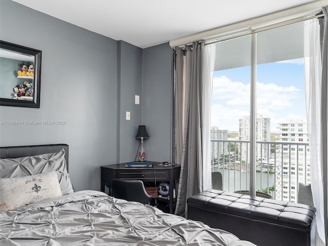 bedroom featuring a water view and access to exterior