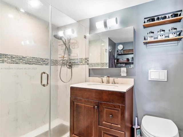 bathroom with vanity, toilet, and a shower with shower door