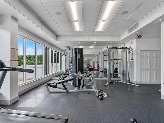 workout area featuring a tray ceiling