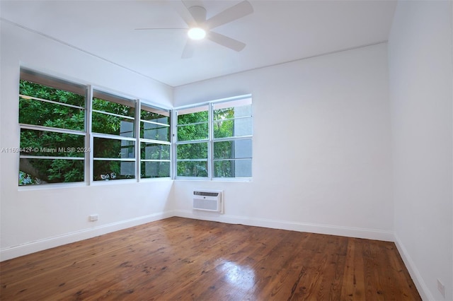 unfurnished room with hardwood / wood-style floors, ceiling fan, and a wall unit AC