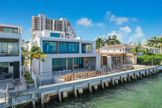 rear view of house featuring a water view