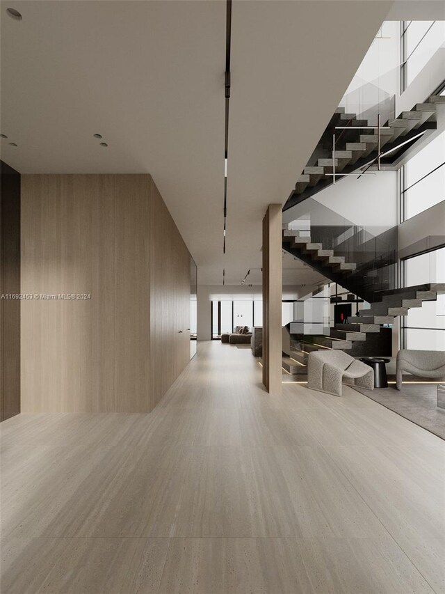 interior space with a towering ceiling and wood walls