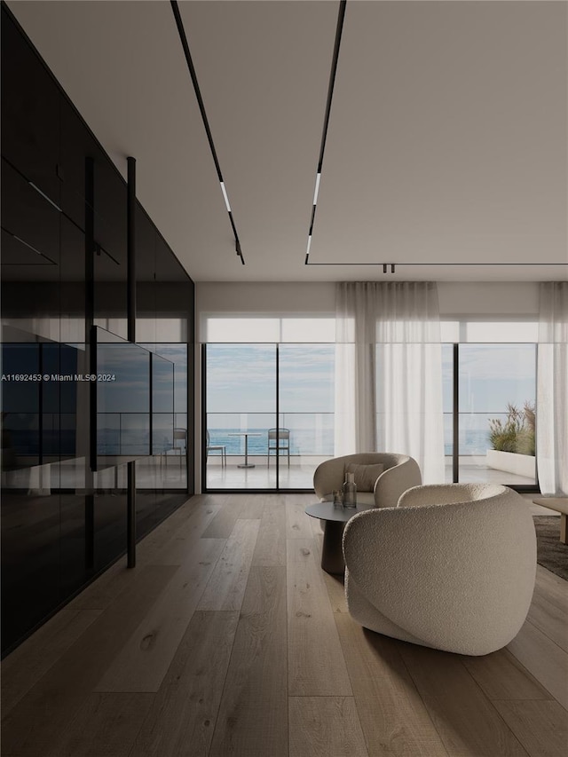 living room with hardwood / wood-style floors and a water view