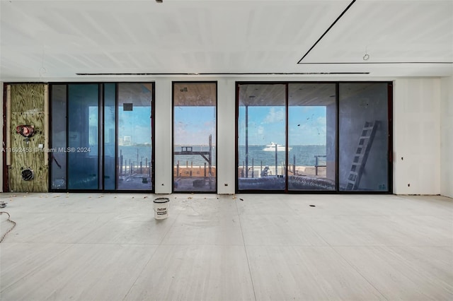 empty room with expansive windows and a water view