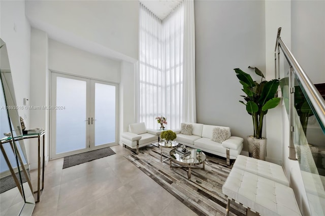 living room featuring french doors and a high ceiling