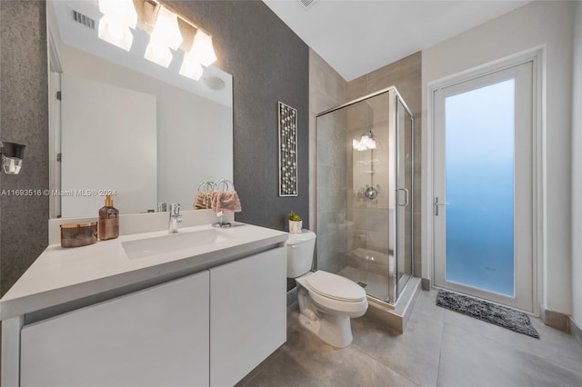 bathroom featuring vanity, toilet, and an enclosed shower