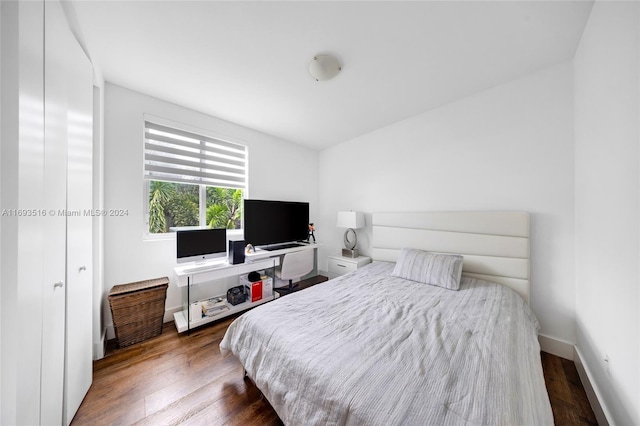 bedroom with dark wood-type flooring