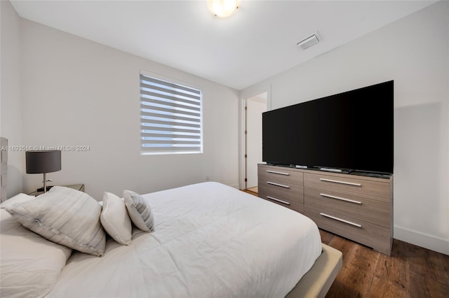 bedroom featuring dark hardwood / wood-style flooring