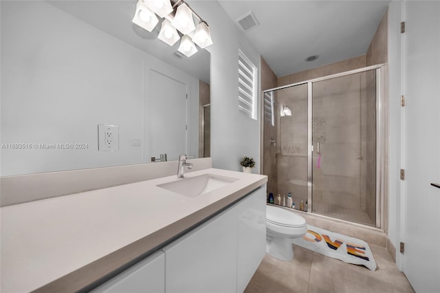 bathroom featuring walk in shower, tile patterned flooring, vanity, and toilet