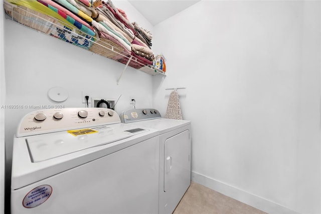 laundry area featuring washing machine and dryer and light colored carpet