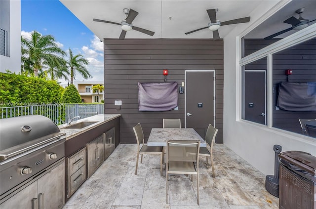 view of patio / terrace featuring a grill, ceiling fan, sink, and area for grilling