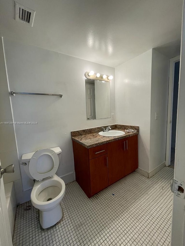 bathroom featuring a bath, vanity, and toilet