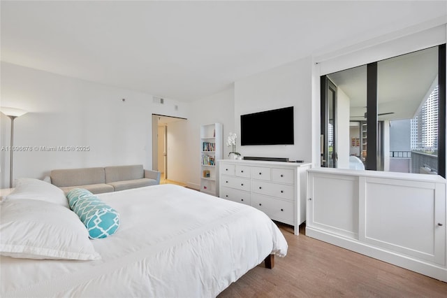 bedroom with hardwood / wood-style flooring