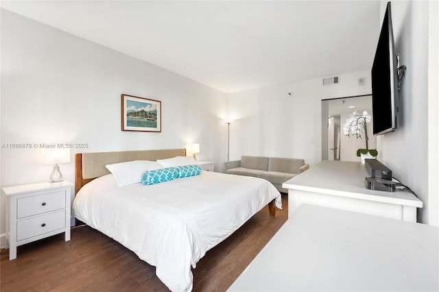 bedroom with dark wood-type flooring