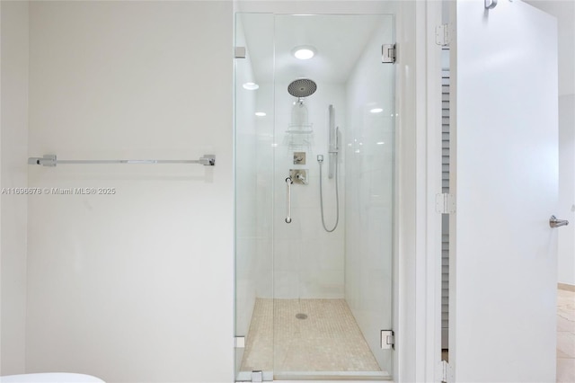 bathroom with tile patterned flooring and a shower with shower door