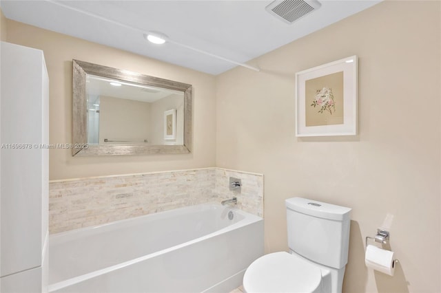 bathroom with a washtub and toilet