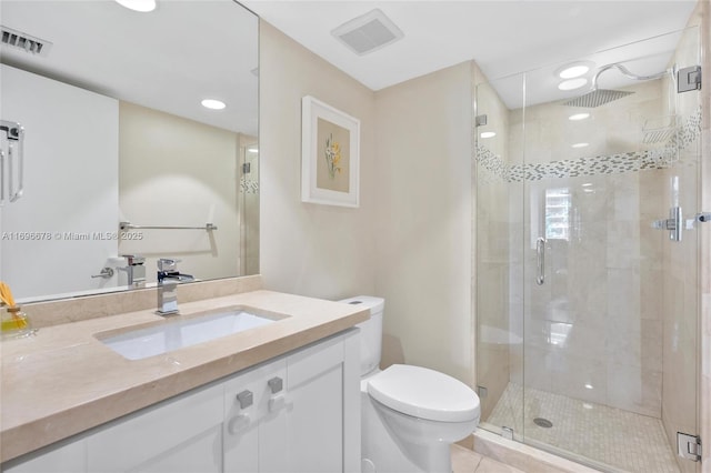 bathroom featuring tile patterned floors, vanity, toilet, and an enclosed shower