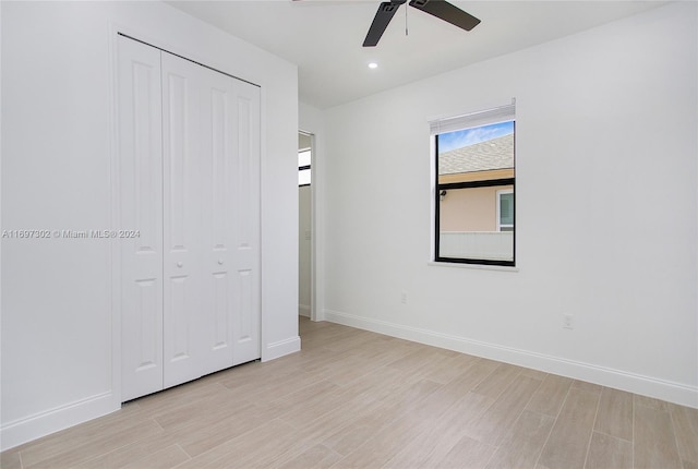 unfurnished bedroom with light wood-type flooring, a closet, and ceiling fan