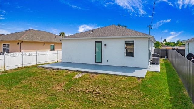 back of property with a yard and a patio