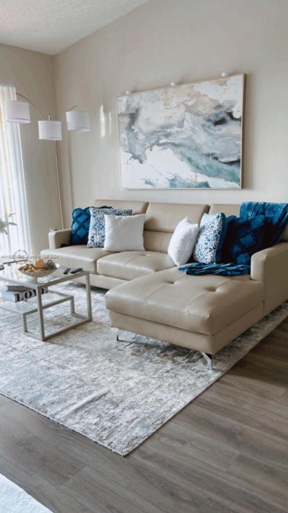 living room featuring hardwood / wood-style floors and a textured ceiling