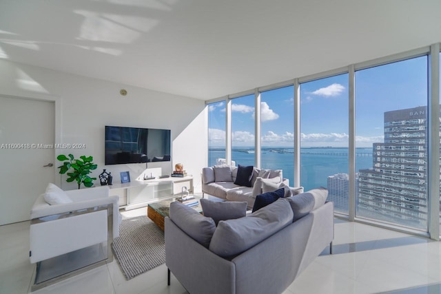 living room with a wall of windows and light tile patterned floors