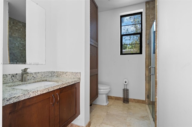 bathroom featuring vanity, walk in shower, and toilet