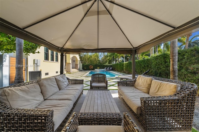 view of patio with a fenced in pool, a gazebo, and outdoor lounge area